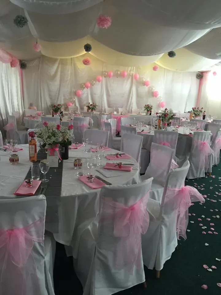 A wedding breakfast layout with pink table details