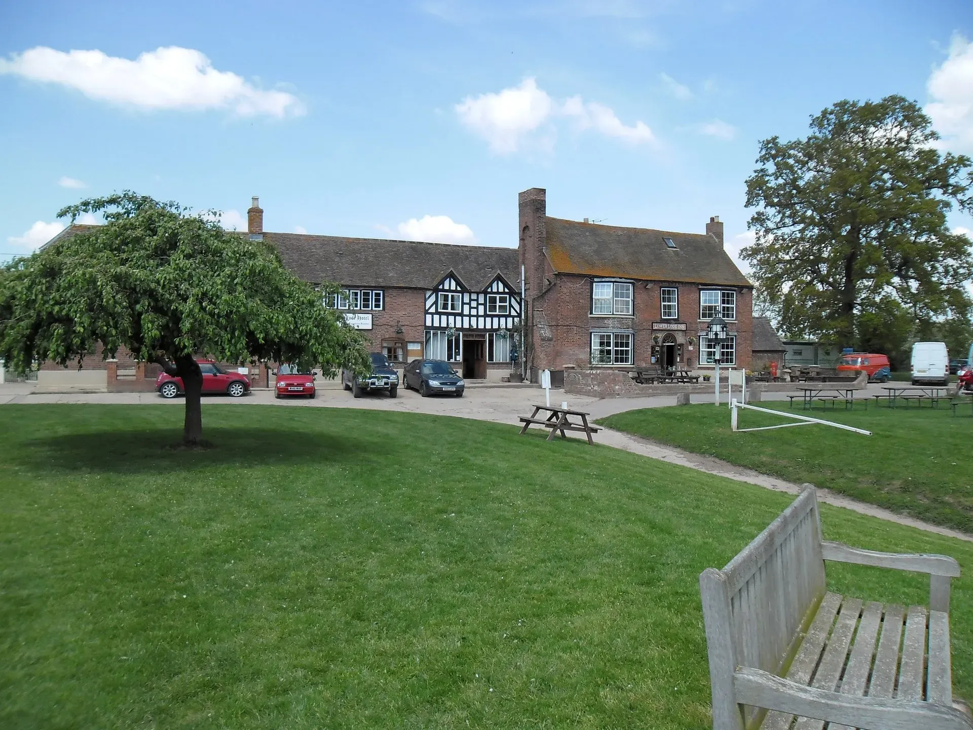 The white-painted Lower Lode Inn beside its garden