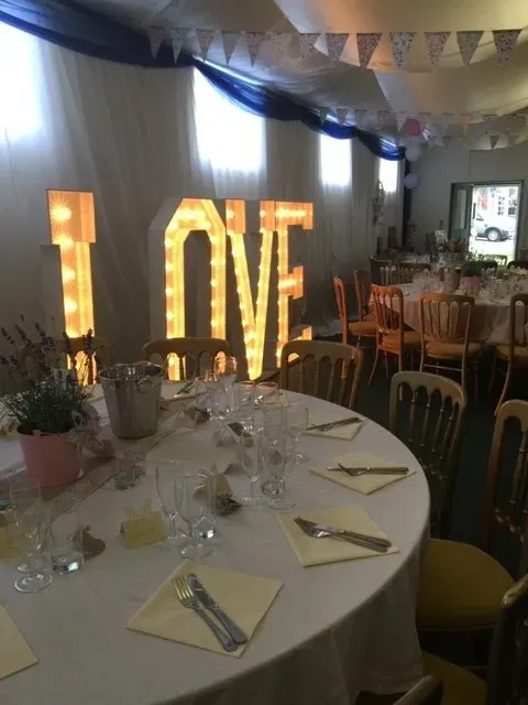 A small wedding table with love letters and flowers