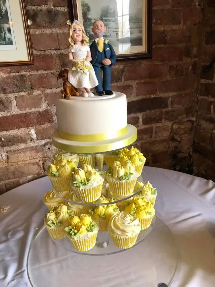 A wedding cake displayed in the decorated hall